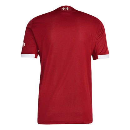 Red sports jersey with brand logo on a light gray background